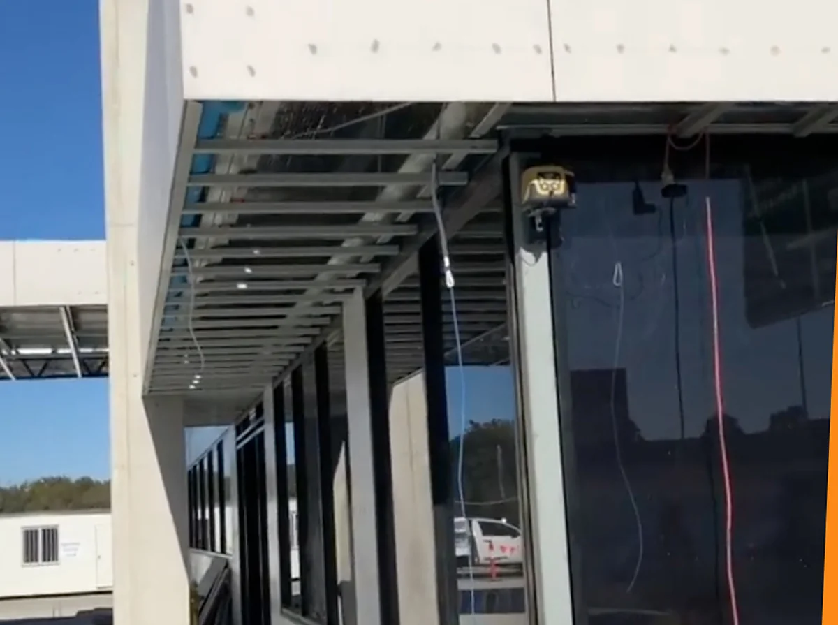 A shop front under construction with steel ceiling framing over the awning and the glazing already in place below.